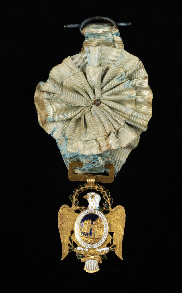 Click for a larger view. Gold insignia of the Society of the Cincinnati on a circular faded blue ribbon